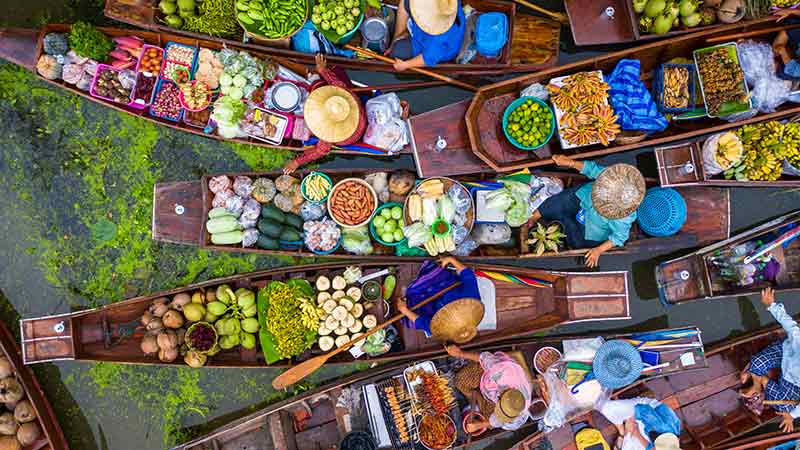 Floating market full of food a traveller might see when they travel to Bangkok
